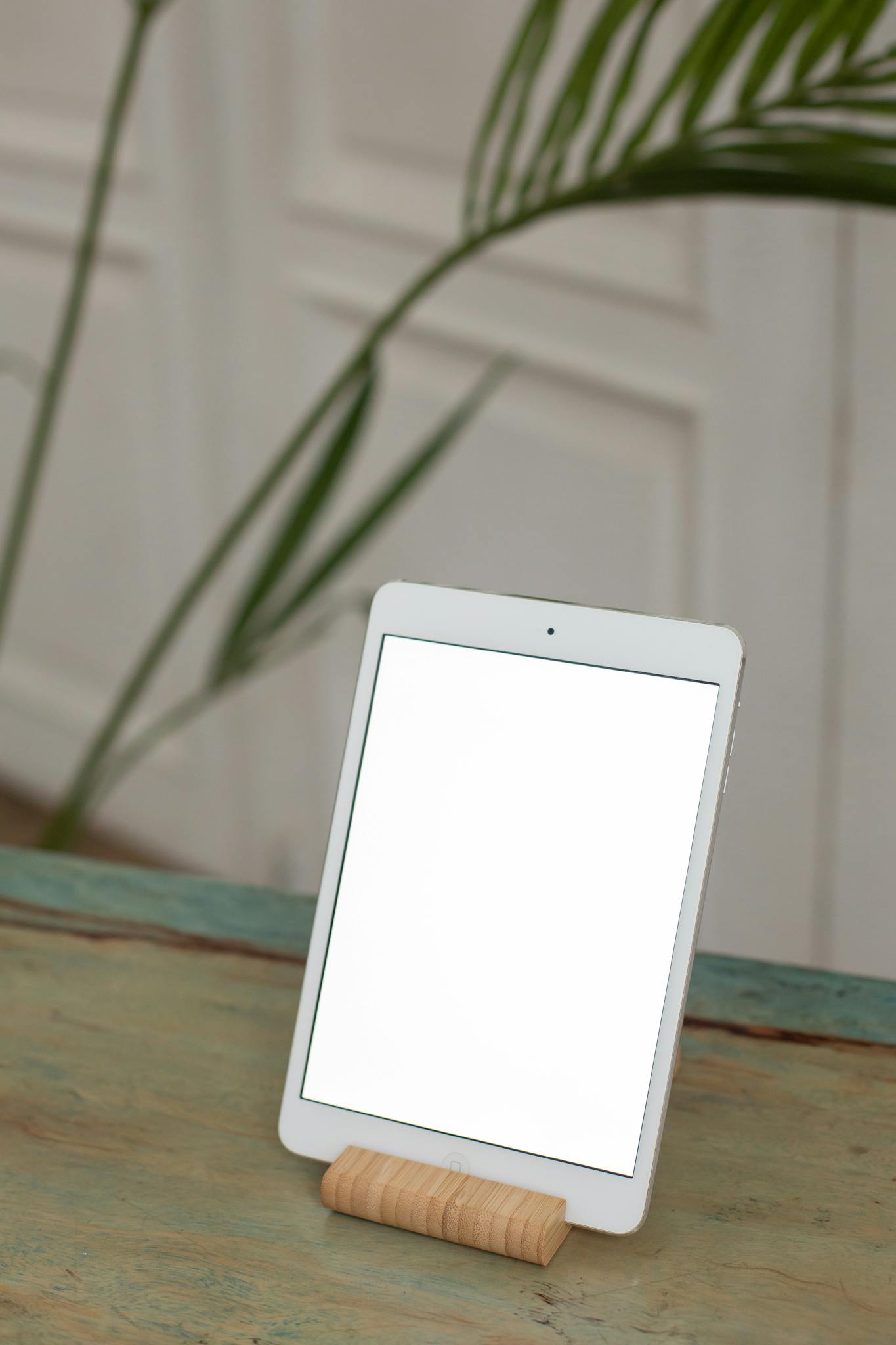 Blank Tablet Screen On Wooden Stand Indoors With Green Plant Background Ideal For Technology Mockups. 6373044 1365x2048