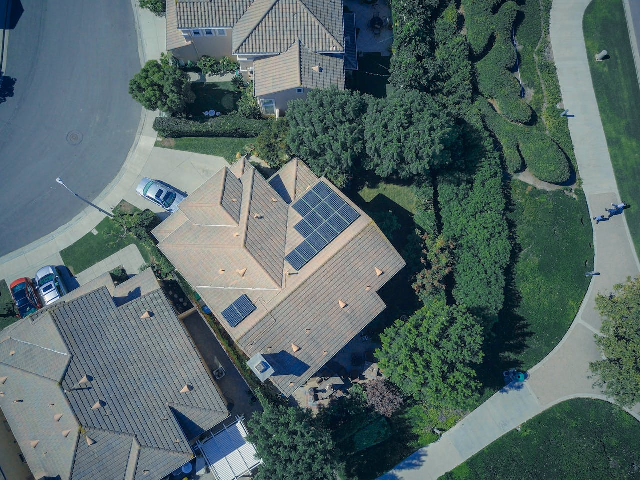 An aerial view showcasing modern suburban houses equipped with solar panels for renewable energy.